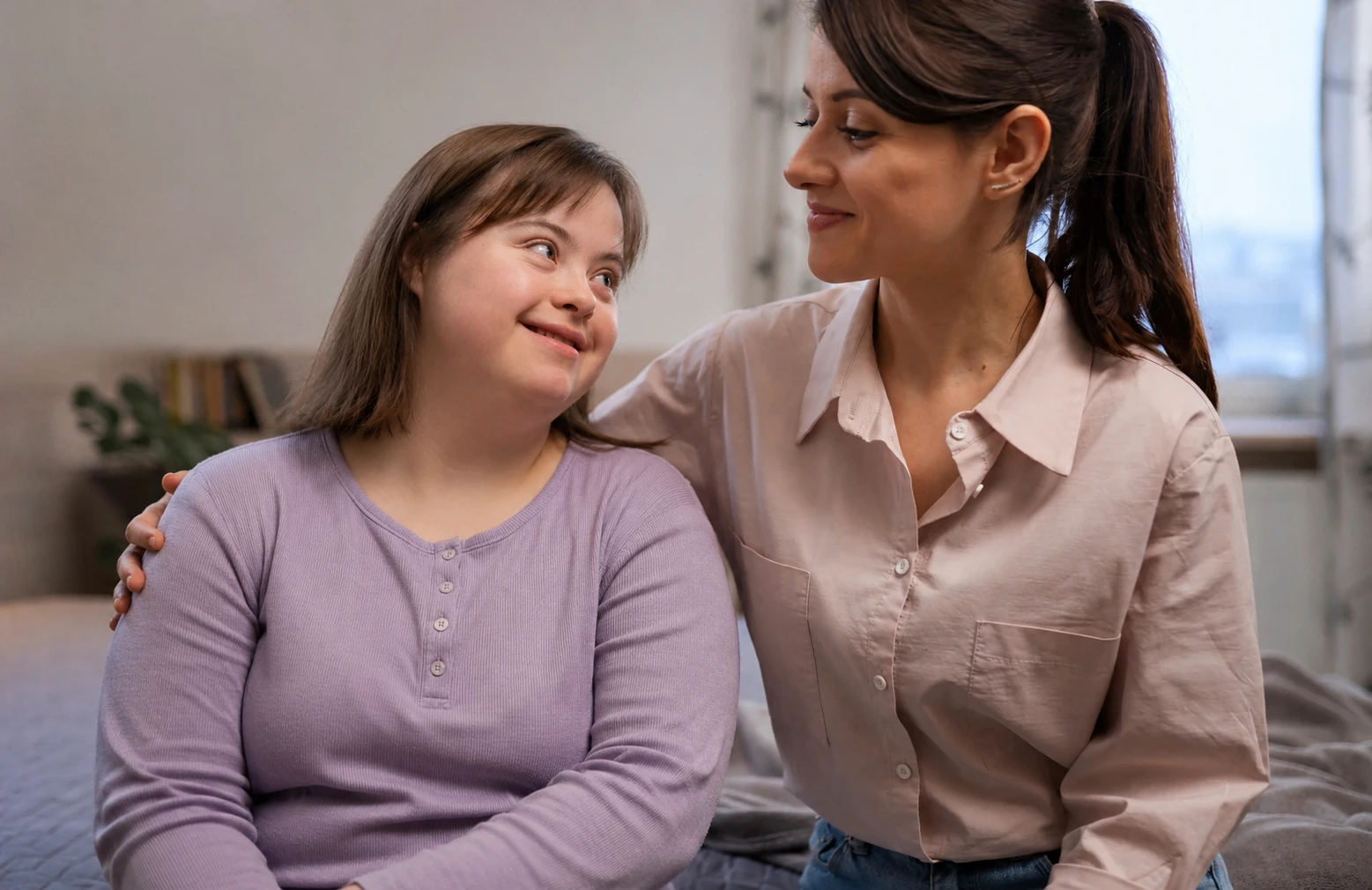 Compassionate caregiver with arm around elderly woman, sharing a warm moment at home